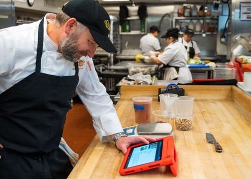 Clyde's manager overlooking menu ingredients