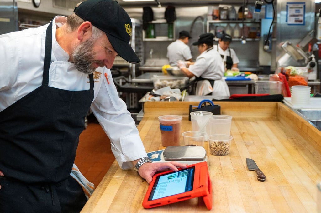Chef using MarginEdge in restaurant kitchen