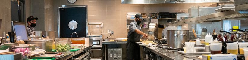 Cooks in restaurant kitchen prepping food