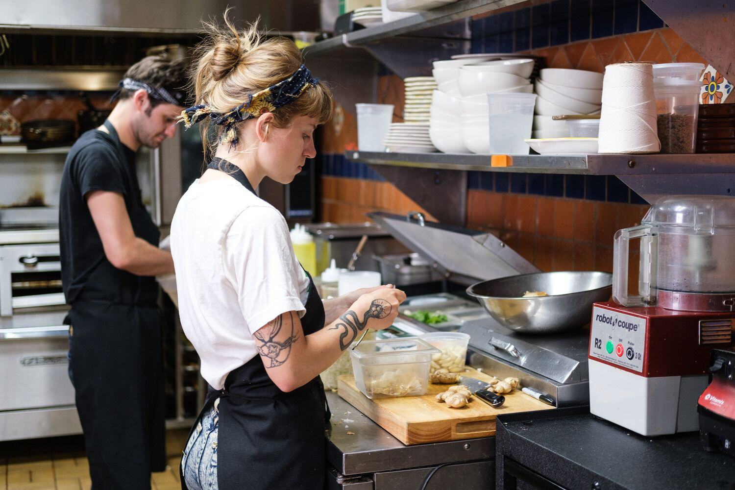 Chefs prepping food in restaurant kitchen